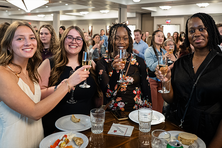 students toasting with champagne at senior toast